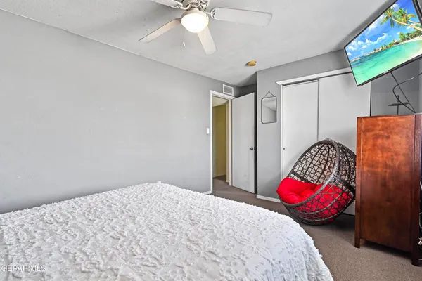a bedroom with a bed and a potted plant