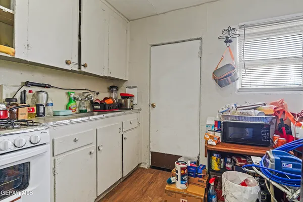 a view of a kitchen with baby cabinets and a window