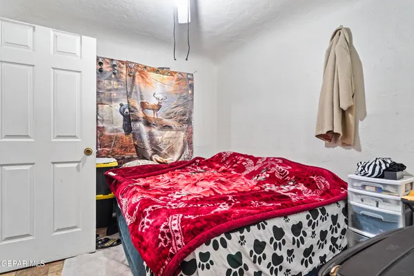 a bedroom with a bed and a table