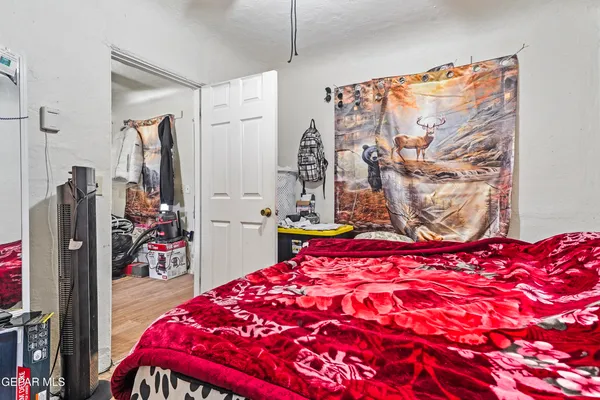 a bedroom with a large bed and a dresser