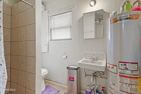 a bathroom with a sink and a shower curtain