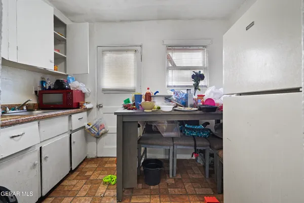 a kitchen with a sink cabinets and dining table