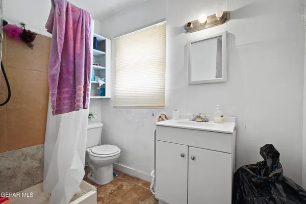 a bathroom with a sink toilet and mirror