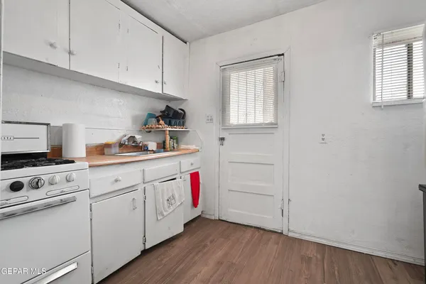 a kitchen with white cabinets and white appliances