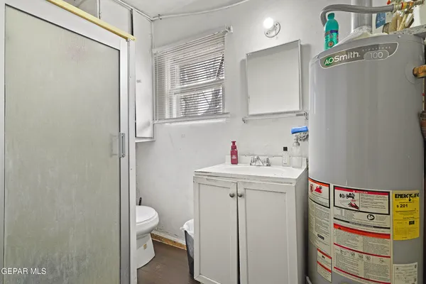 a bathroom with a sink a toilet and a mirror