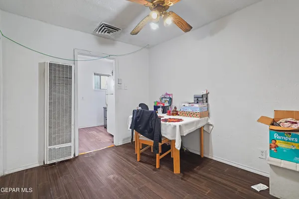 a view of a workspace with furniture and wooden floor