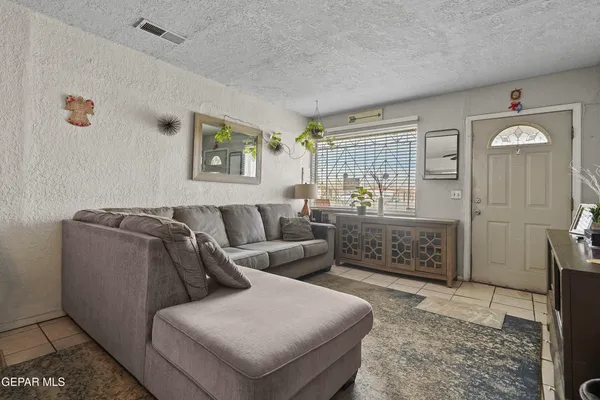 a living room with furniture and painting on the wall