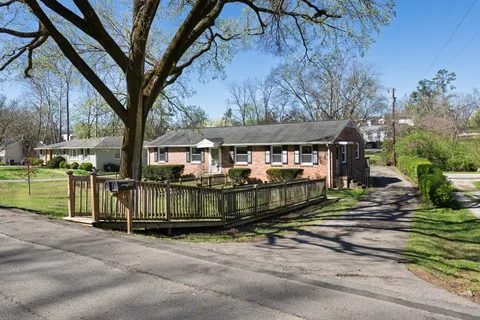 a view of house with a yard