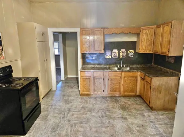 a kitchen with a sink stove and cabinets