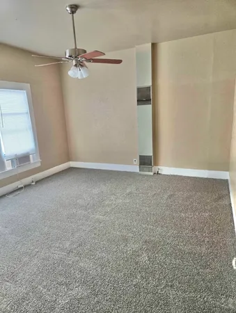 a view of an empty room with a window