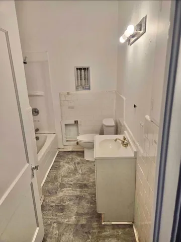 a bathroom with a sink a toilet and a mirror