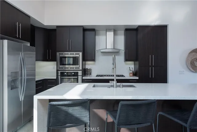 a kitchen with a sink cabinets and refrigerator