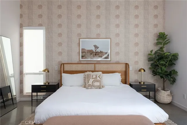 a bedroom with a bed and a potted plant