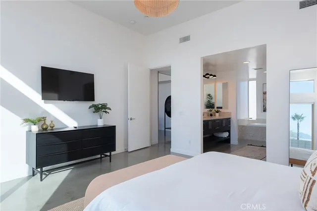 a bedroom with bed and television