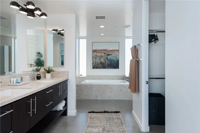 a bathroom with a double vanity sink a mirror and a shower