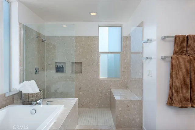 a bathroom with a tub sink and mirror