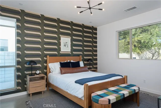 a bedroom with a bed and a window