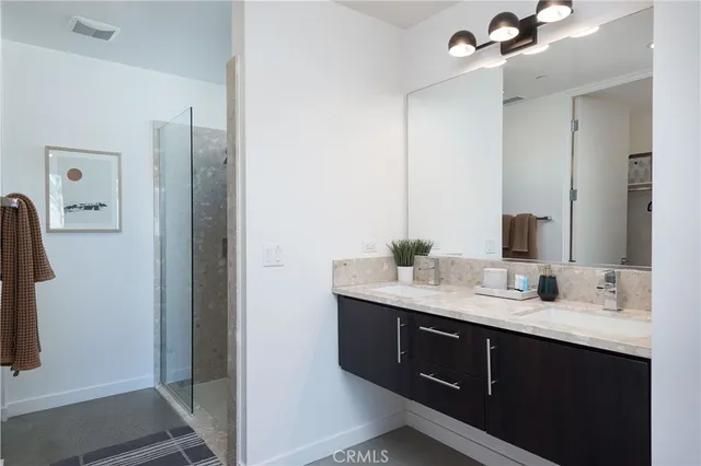 a bathroom with a double vanity sink and mirror