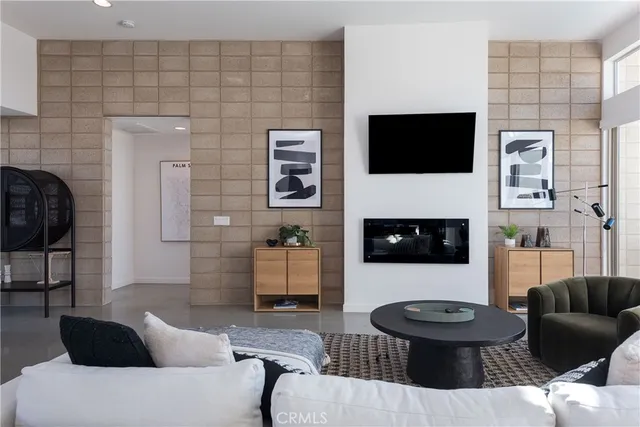 a living room with furniture a flat screen tv and a fireplace