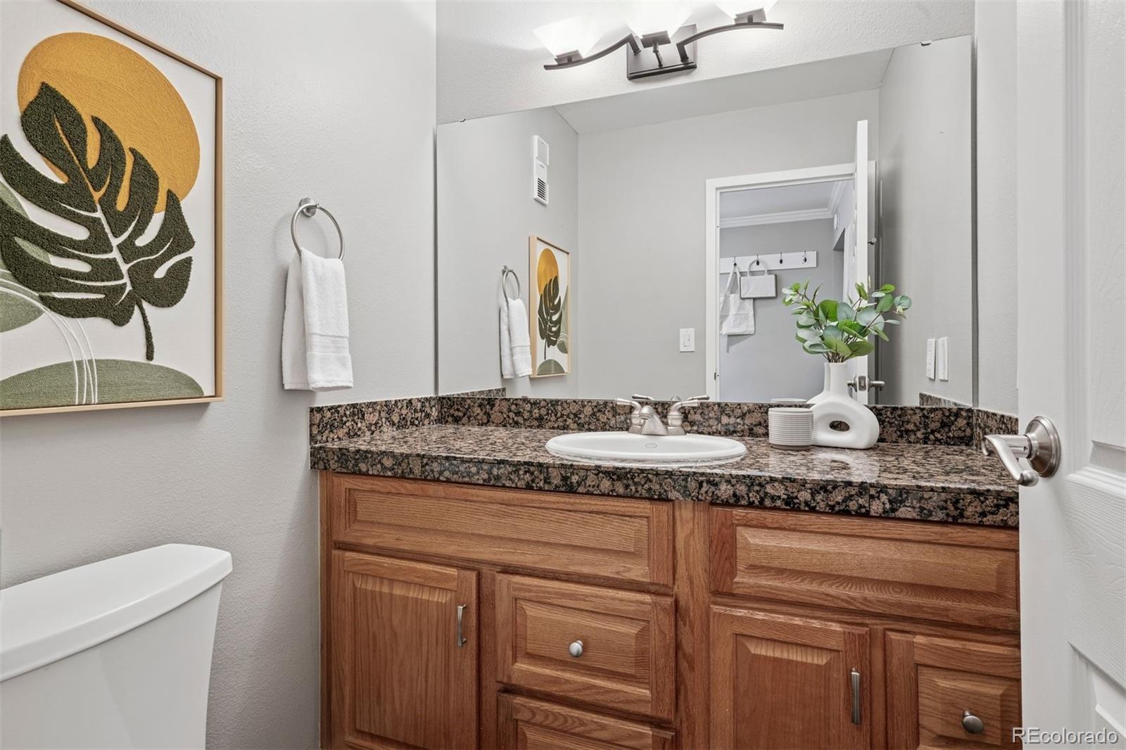1625 Larimer Street, Unit 1208 Denver, CO 80202 - Photo 19 of 41 a bathroom with a granite countertop sink and a mirror