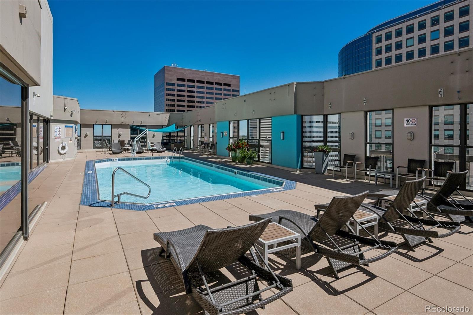 1625 Larimer Street, Unit 1208 Denver, CO 80202 - Photo 21 of 41 a view of a patio with swimming pool table and chairs