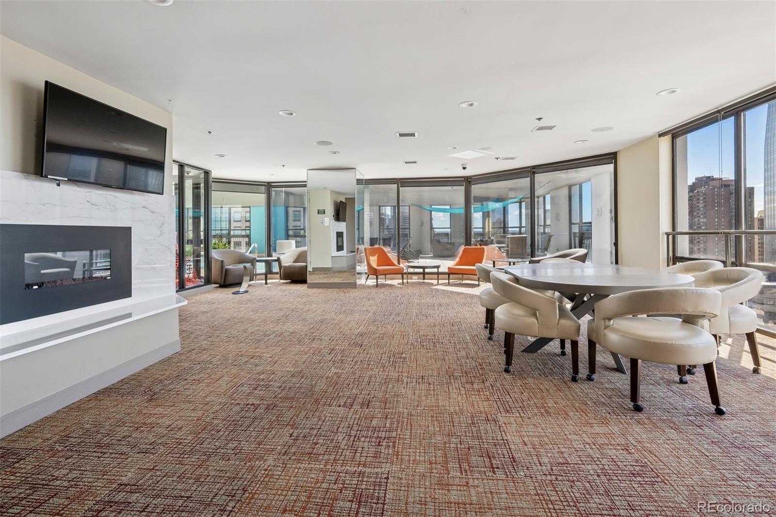 1625 Larimer Street, Unit 1208 Denver, CO 80202 - Photo 27 of 41 a living room with furniture a flat screen tv and a fireplace