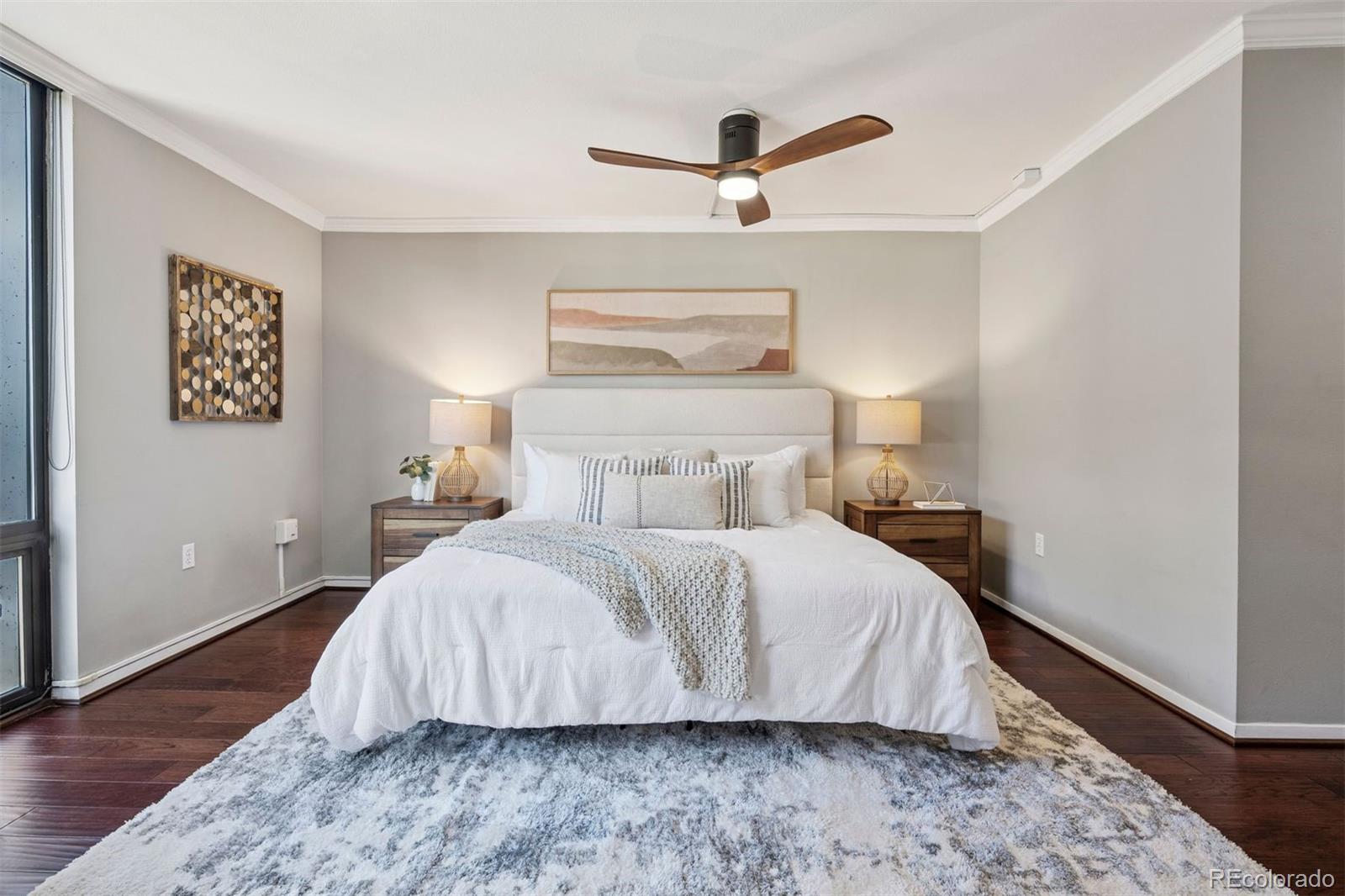 1625 Larimer Street, Unit 1208 Denver, CO 80202 - Photo 3 of 41 a bedroom with a bed and wooden floor