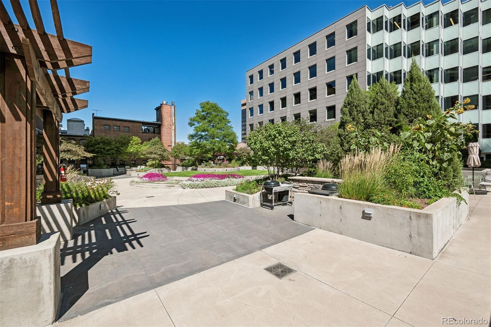 1625 Larimer Street, Unit 1208 Denver, CO 80202 - Photo 5 of 41 a view of a patio with a table and chairs and potted plants