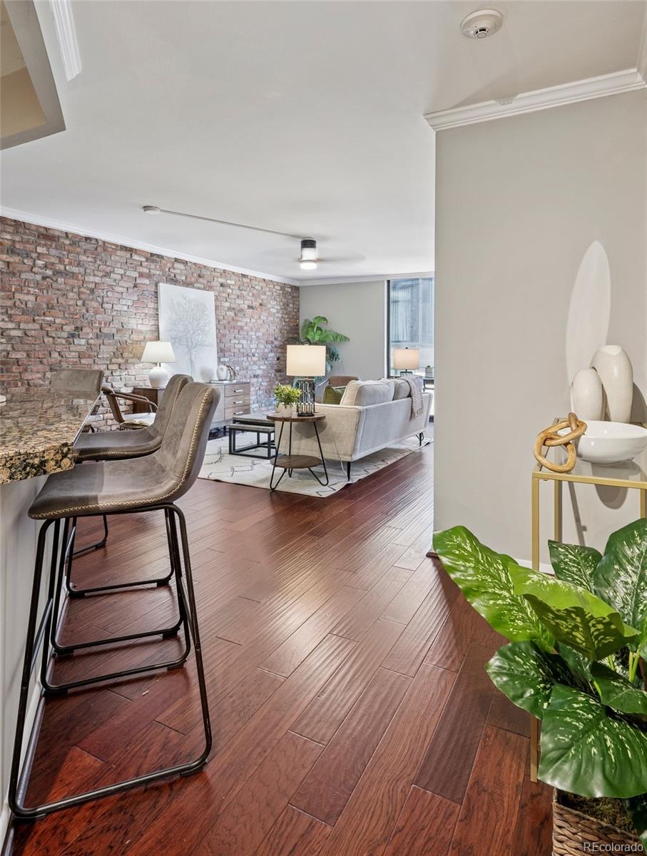 1625 Larimer Street, Unit 1208 Denver, CO 80202 - Photo 6 of 41 a living room with furniture and a wooden floor