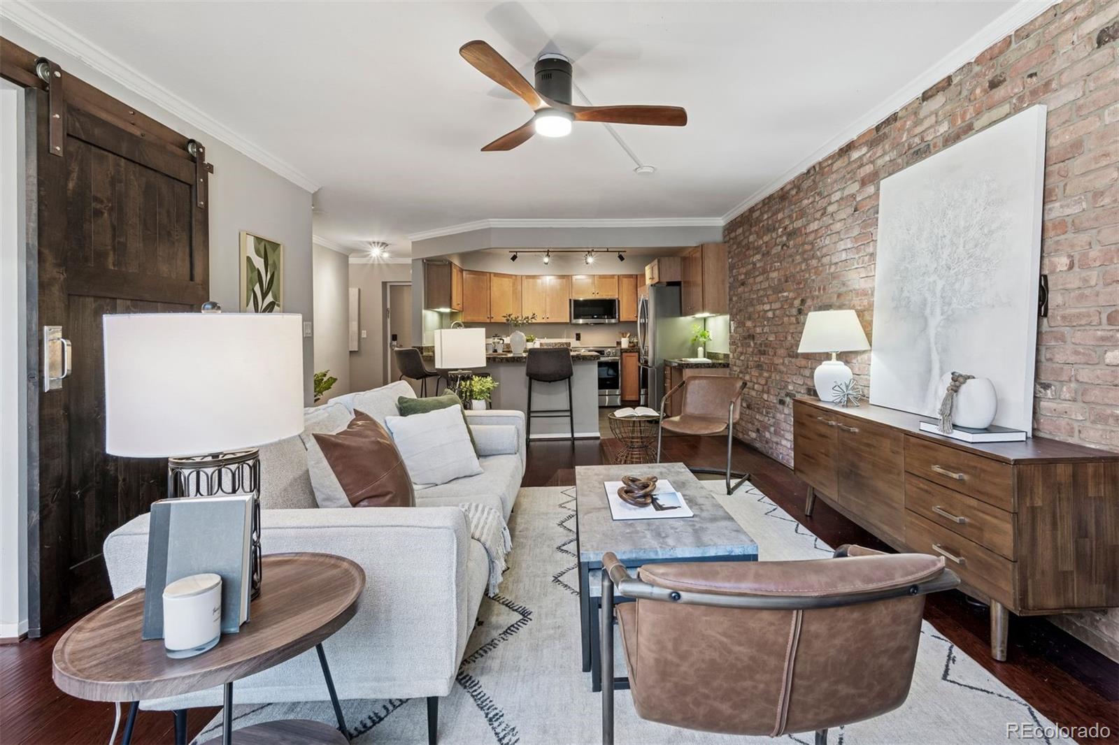 1625 Larimer Street, Unit 1208 Denver, CO 80202 - Photo 9 of 41 a living room with furniture and a large window
