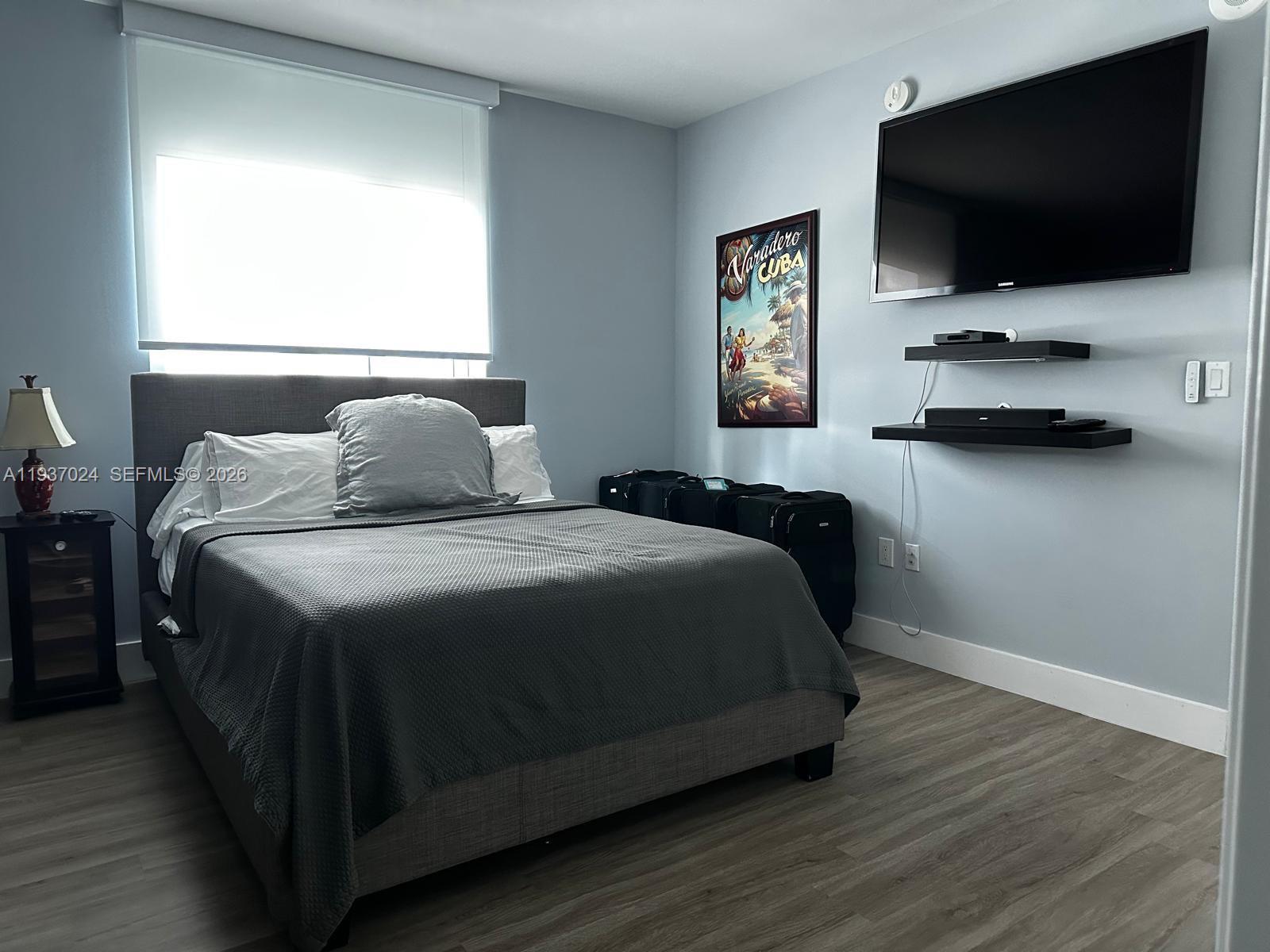 500 Brickell Avenue, Unit 3307 Miami, FL 33131 - Photo 14 of 30 a bedroom with a bed and a flat screen tv