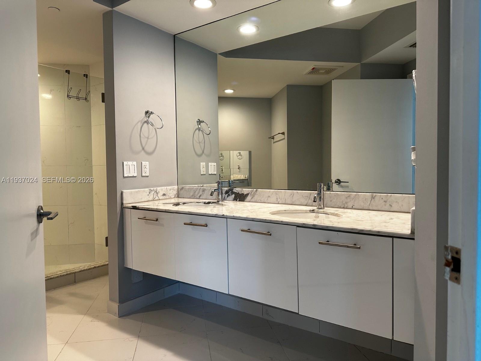 500 Brickell Avenue, Unit 3307 Miami, FL 33131 - Photo 18 of 30 a bathroom with a double vanity sink mirror and double