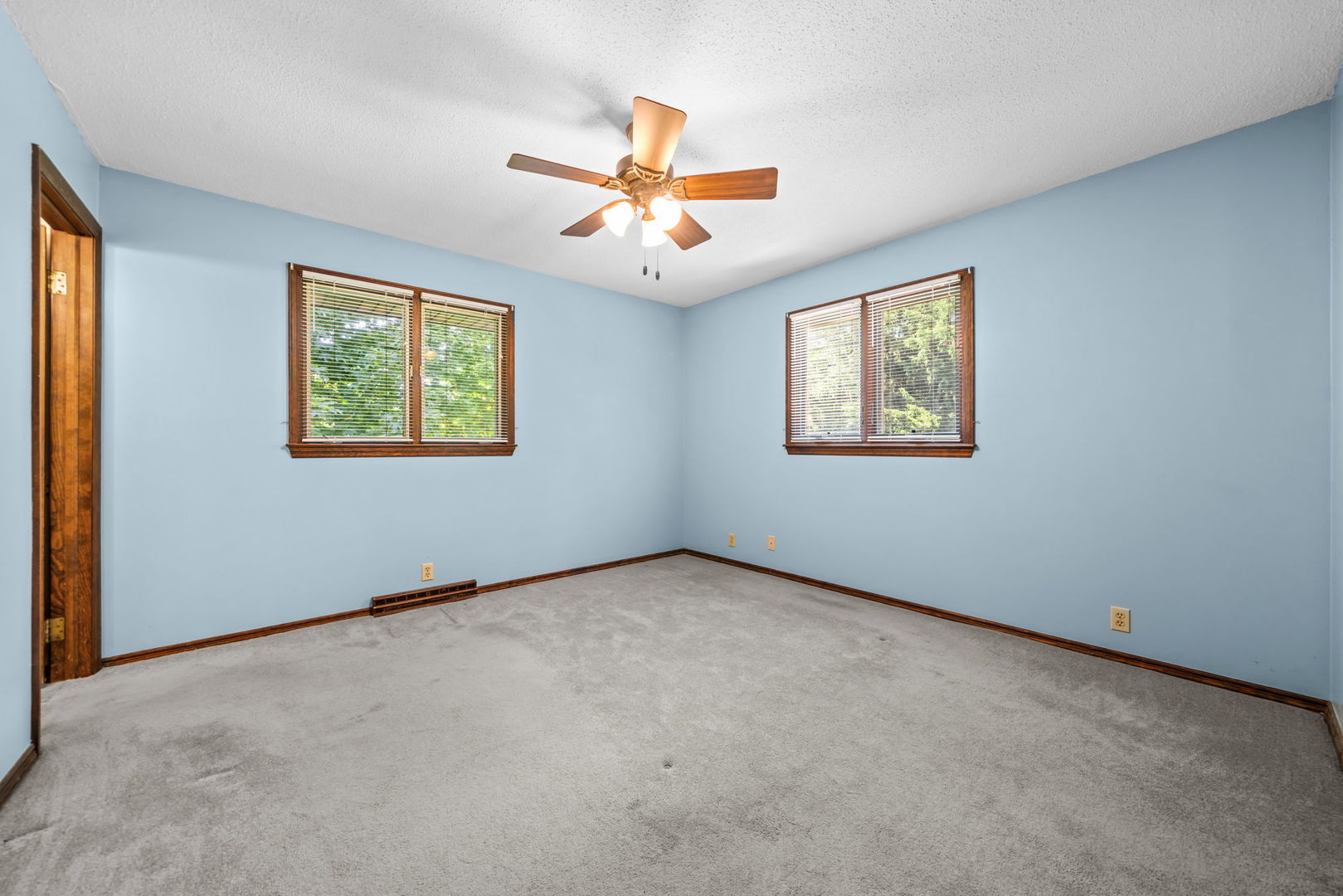 5748 South Skare Road Rochelle, IL 61068 - Photo 15 of 45 an empty room with windows and ceiling fan