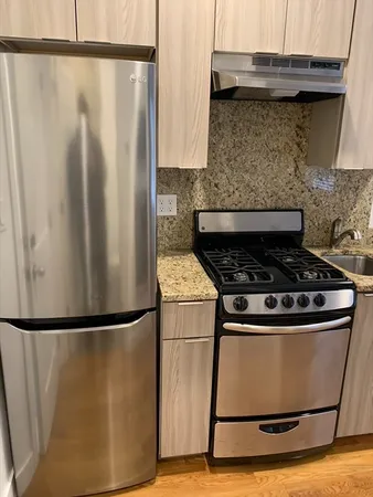 a close view of a stove top oven and cabinets