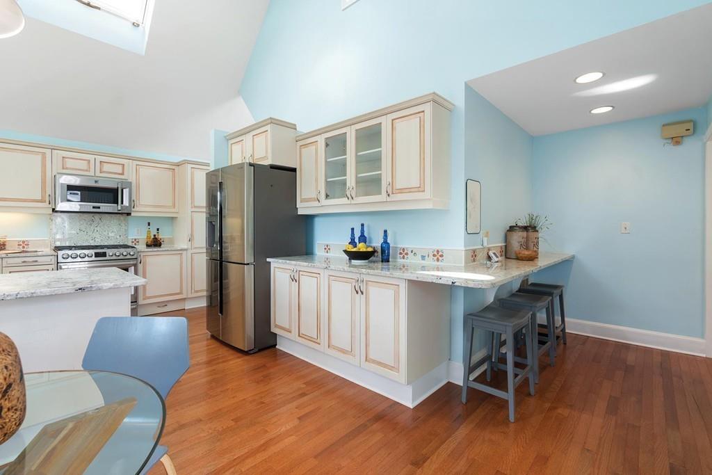 118 Wallis Road Brookline, MA 02467 - Photo 11 of 29 a kitchen with stainless steel appliances granite countertop a refrigerator and a stove top oven