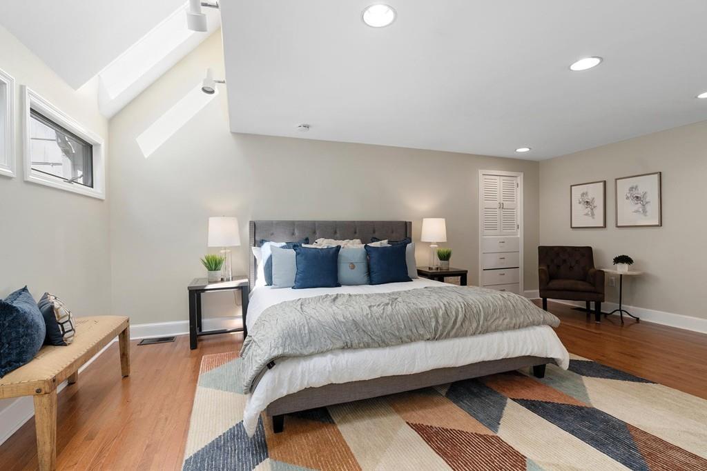118 Wallis Road Brookline, MA 02467 - Photo 12 of 29 a bedroom with a bed and wooden floor