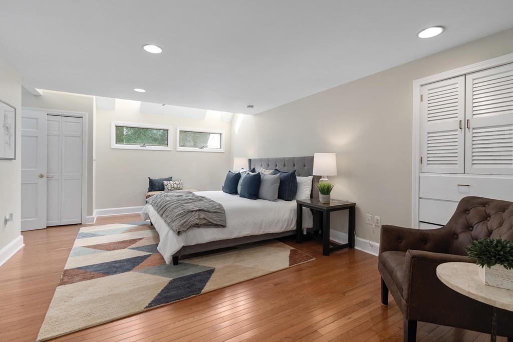 118 Wallis Road Brookline, MA 02467 - Photo 13 of 29 a bedroom with a bed and wooden floor