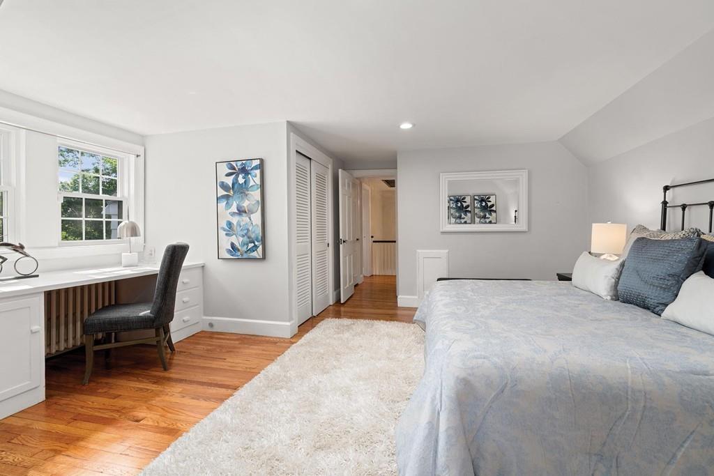 118 Wallis Road Brookline, MA 02467 - Photo 16 of 29 a bedroom with a bed a table and chair