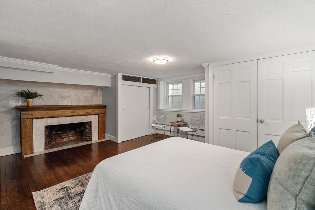 118 Wallis Road Brookline, MA 02467 - Photo 21 of 29 a bedroom with a bed and a fireplace