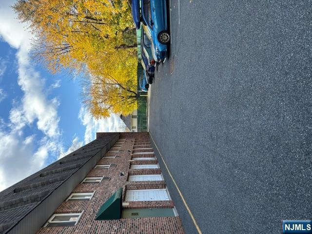 1 Simone Place, Unit 2F Bergenfield, NJ 07621 - Photo 13 of 13 a view of a street with a cars parked in front of house