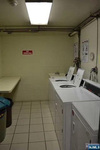a utility room with a sink a vanity and a toilet