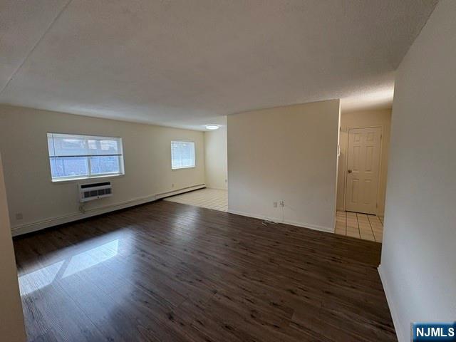 1 Simone Place, Unit 2F Bergenfield, NJ 07621 - Photo 7 of 13 an empty room with wooden floor and windows