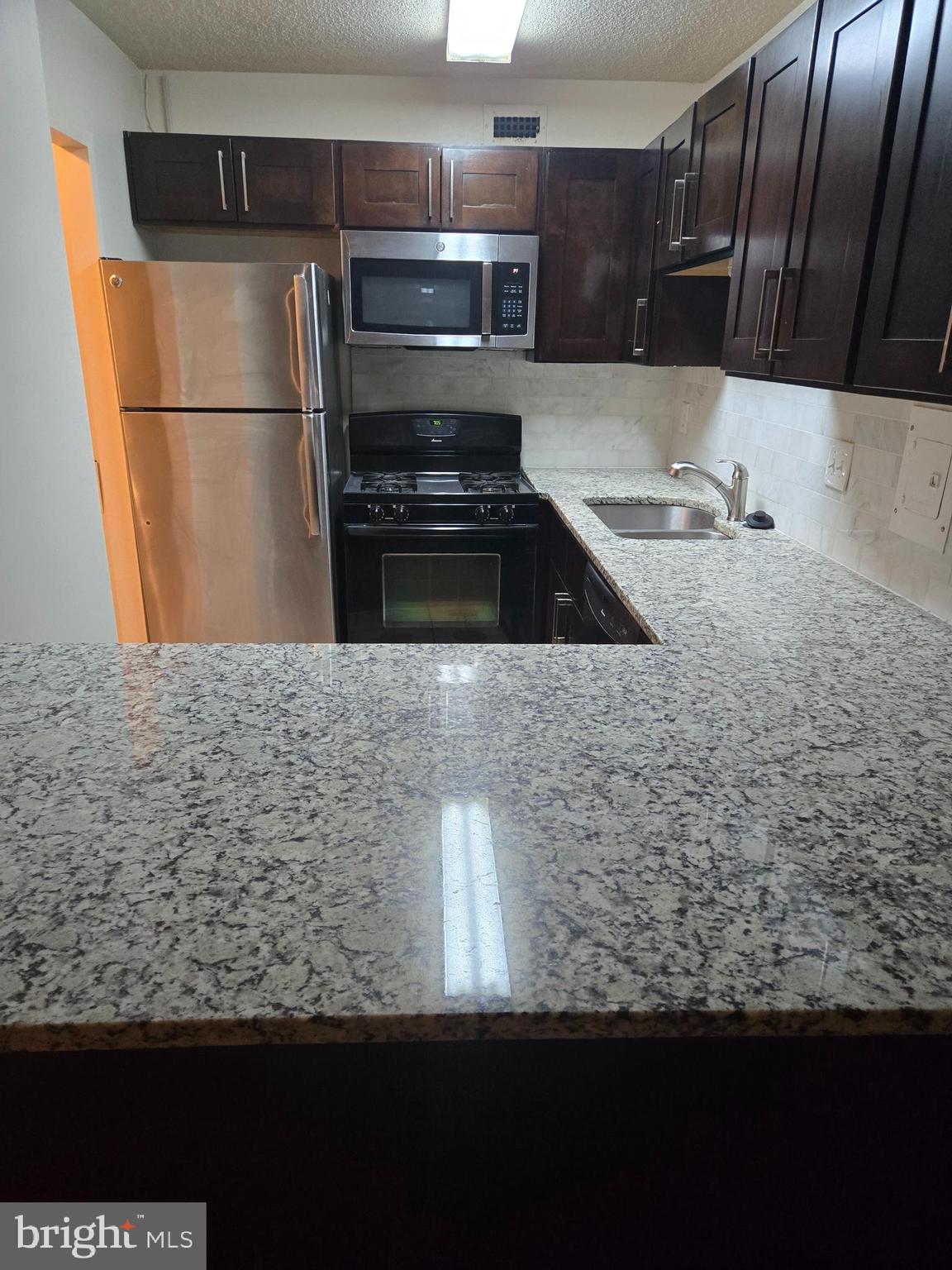 a kitchen with kitchen island a counter top space and cabinets