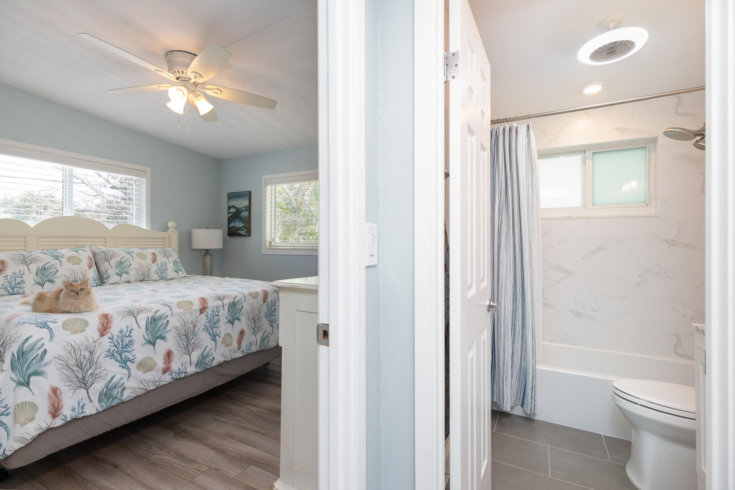 39 Lake Shore Drive Key Largo, FL 33037 - Photo 15 of 47 a spacious bedroom with a large bed and a chandelier