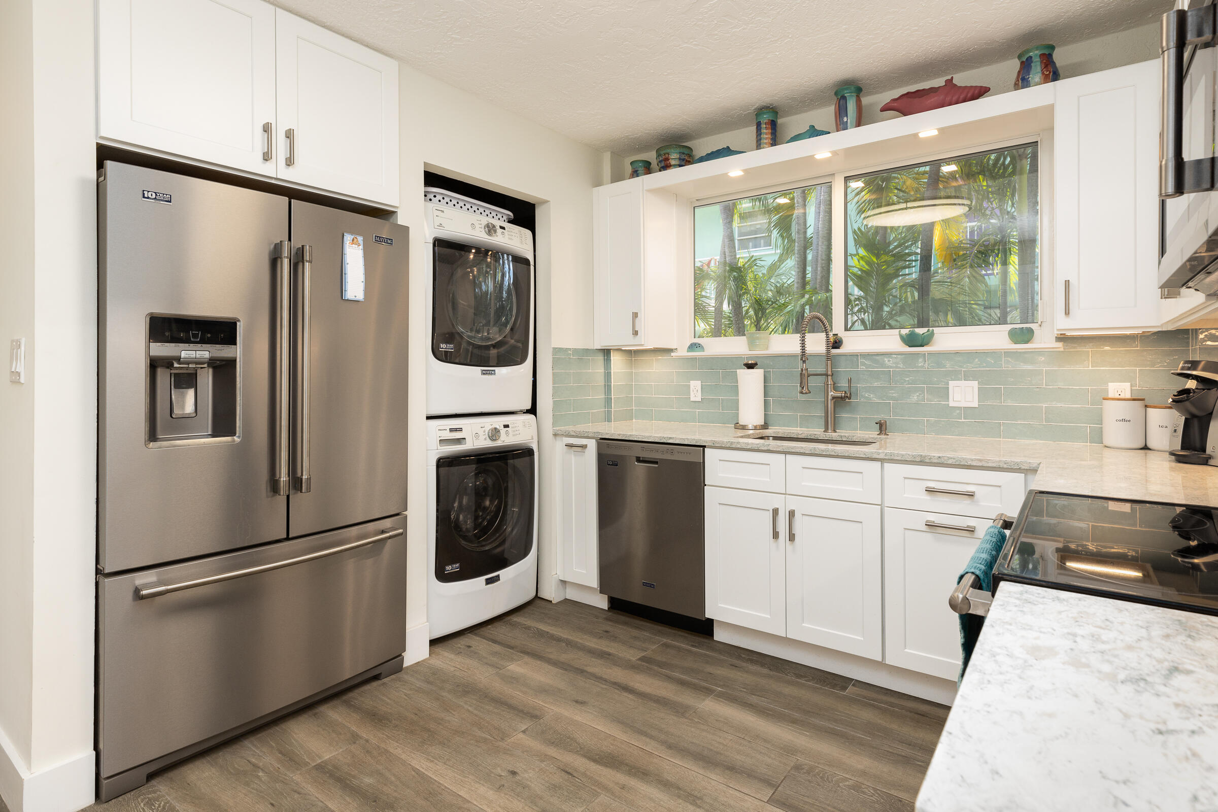 39 Lake Shore Drive Key Largo, FL 33037 - Photo 30 of 47 a kitchen with stainless steel appliances a refrigerator sink and cabinets
