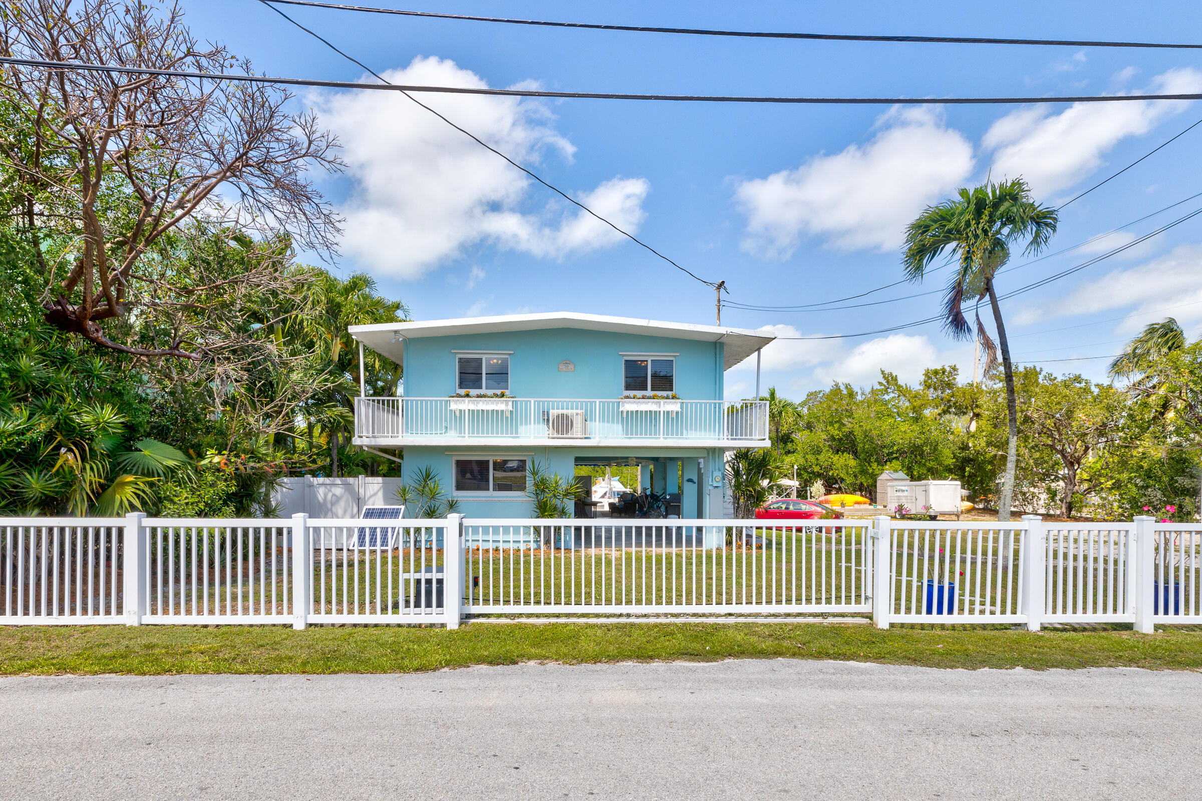 39 Lake Shore Drive Key Largo, FL 33037 - Photo 38 of 47 a view of a house with a small yard and a large tree