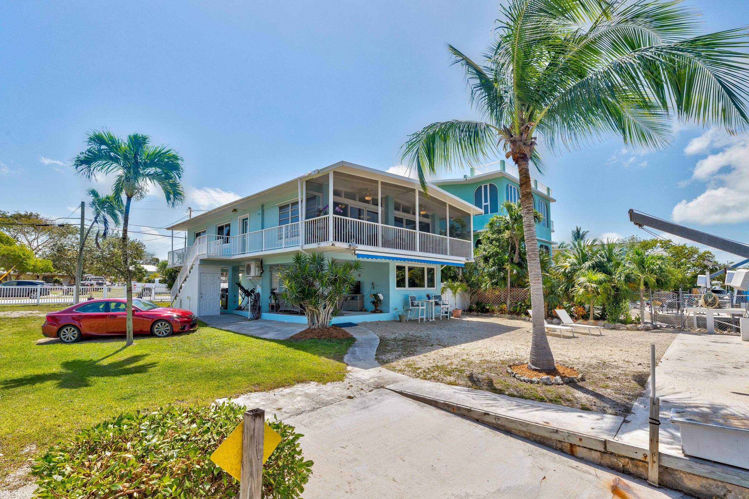39 Lake Shore Drive Key Largo, FL 33037 - Photo 40 of 47 a front view of a building with garden and trees