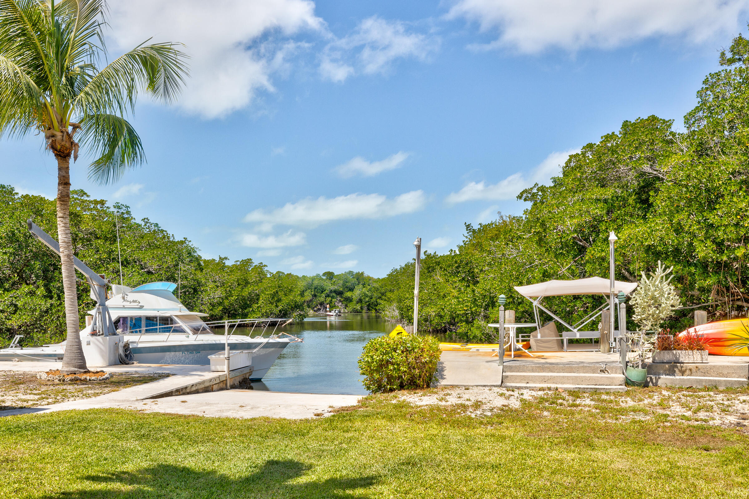 39 Lake Shore Drive Key Largo, FL 33037 - Photo 41 of 47 a view of a swimming pool with a lawn chairs under an umbrella