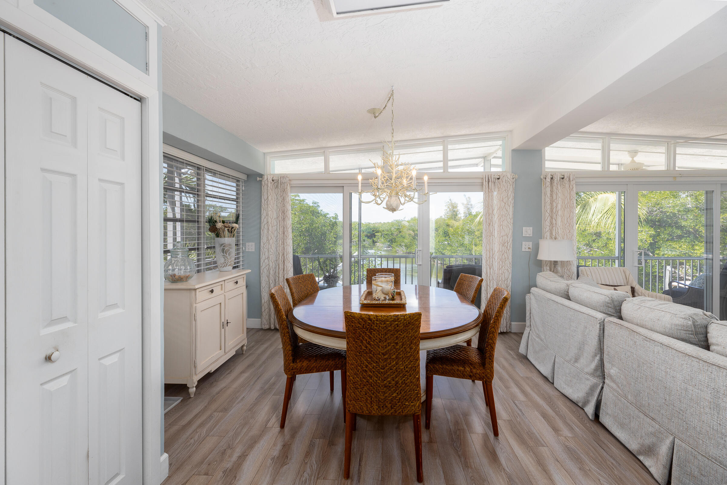 39 Lake Shore Drive Key Largo, FL 33037 - Photo 5 of 47 a dining room with furniture window wooden floor and a chandelier