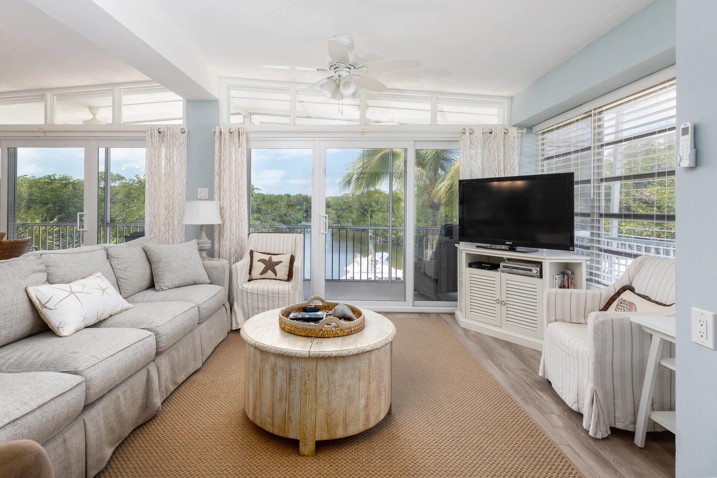 39 Lake Shore Drive Key Largo, FL 33037 - Photo 9 of 47 a living room with furniture a flat screen tv and a large window